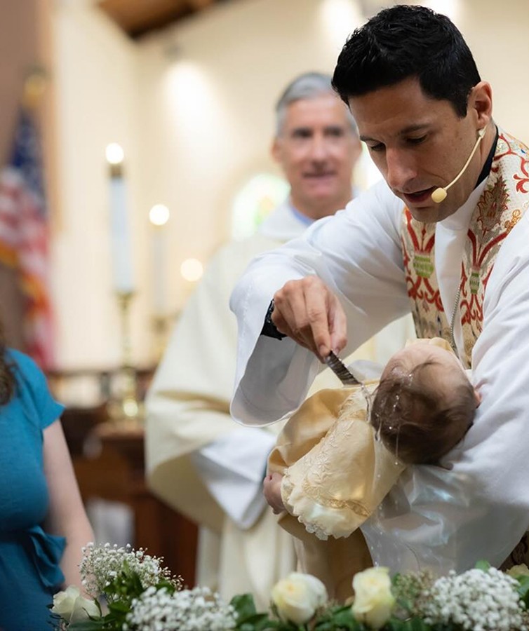Pastor baptising child